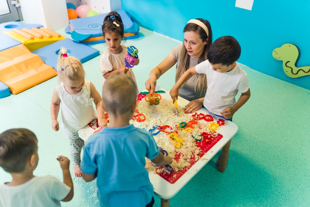 Children at preschool doing a project with their teacher
