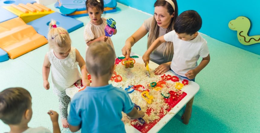 Children at preschool doing a project with their teacher