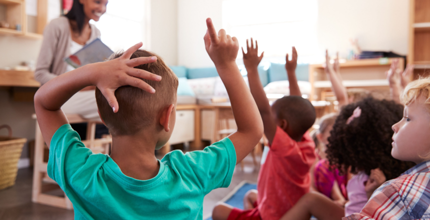 Featured image showing Pupils at Montessori School raising hands to answer question.